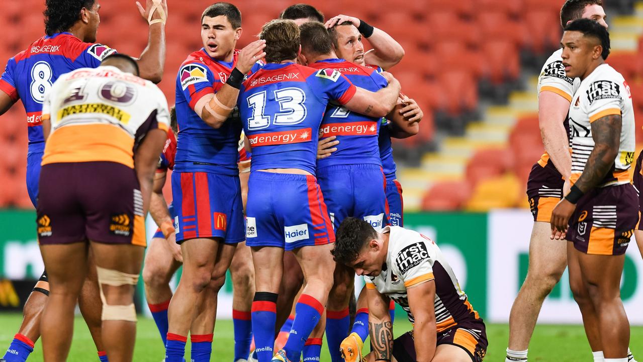 The Knights get around Mitchell Pearce after a try. Picture NRL Images