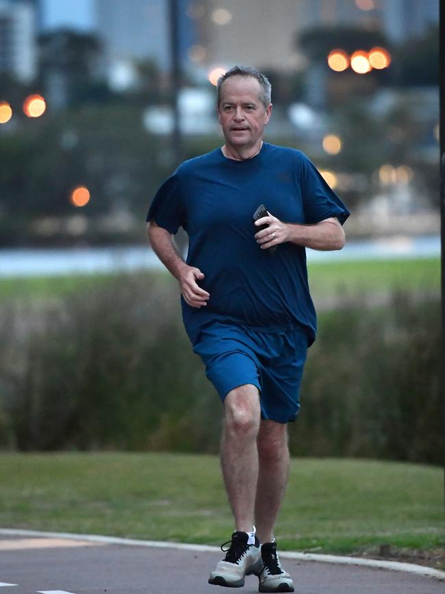 Mr Shorten started the day with a run along the banks of the Swan River on Monday. Picture: AAP/Darren England