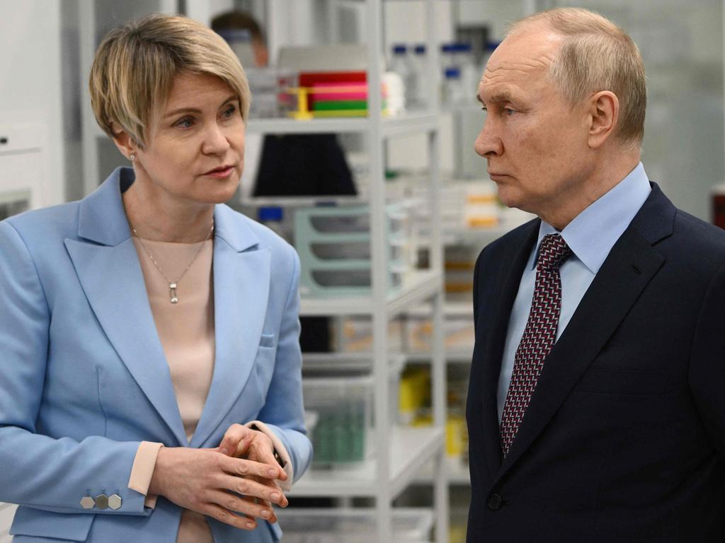 Russian President Vladimir Putin speaks with a head of the educational foundation Sirius Elena Shmeleva, as they visit laboratory facilities of the Sirius University of Science and Technology in Sochi on December 1. Picture: AFP