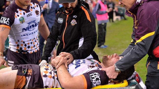 BRISBANE, AUSTRALIA - MAY 19: Andrew McCullough of the Broncos is taken from the field injured during the round 11 NRL match between the Brisbane Broncos and the Wests Tigers at Suncorp Stadium on May 19, 2017 in Brisbane, Australia (Photo by Bradley Kanaris/Getty Images)