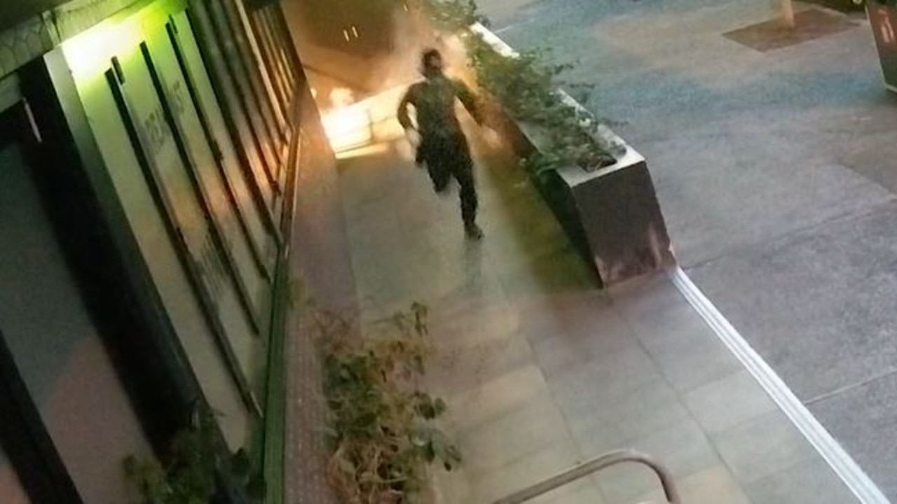 The man is seen running off after lighting a flare.