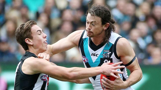 Strong game ... Port Adelaide's Jasper Pittard fends off Collingwood's Callum Brown. Picture: George Salpigtidis