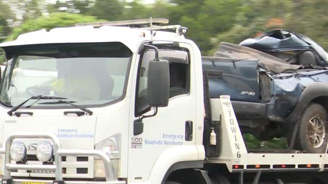 The Mazda on the back of a tow truck.