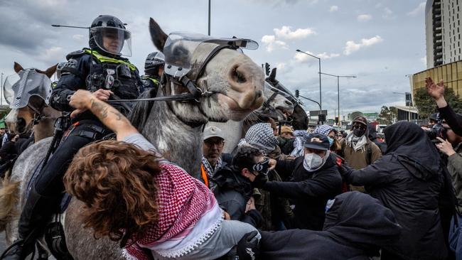 Protesters confront police outside the Land Forces 2024 arms fair in Melbourne on Wednesday. Picture: Jake Nowakowski