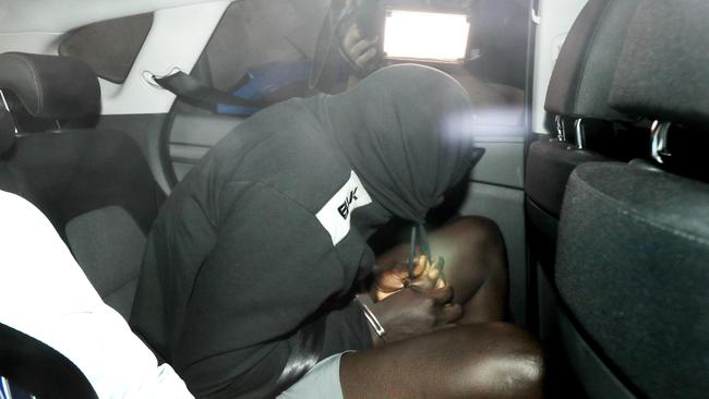 A man arrives at the Brisbane Watchhouse in relation to the murder of Girum Mekonnen at Zillmere. Picture: Tara Croser.