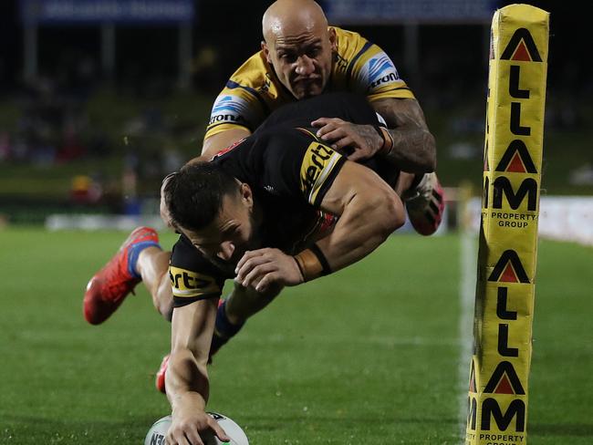 Penrith's Josh Mansour despite the best efforts of Blake Ferguson in defence. Picture: Brett Costello