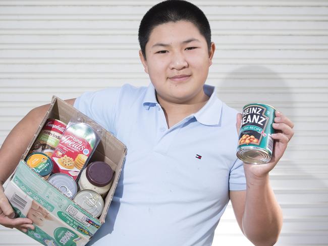 Joshua Tran (12) poses for a photograph at his home in Liverpool, NSW, Australia, 14 July, 2017.  Joshua, who was diagnosed with autism, was encouraged and helped by his mother to start a 'Pay it Forward' Facebook page that sees people give away unwanted items to people that could use them for free. (AAP Photo/Melvyn Knipe)