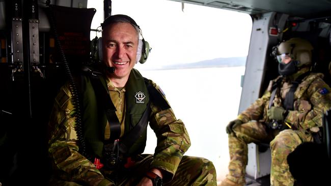 Mark Beretta on board an MRH-90 during a flypass over the Townsville 400 Supercars event. Picture: Alix Sweeney