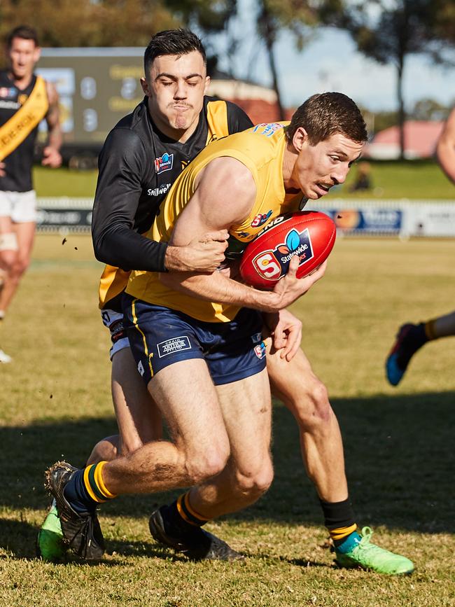 Brad Close of Glenelg tackles Louis Sharrad of the Eagles. Picture: Matt Loxton