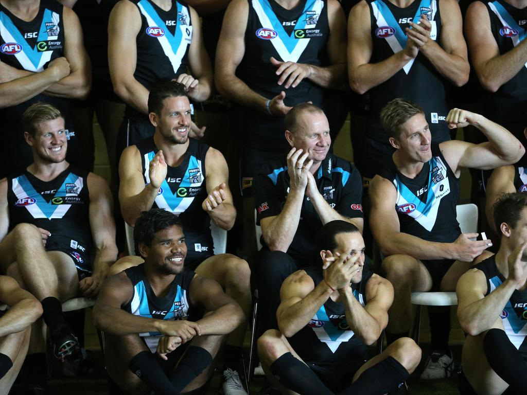 Travis Boak, Ken Hinkley, and Hamish Hartlett have a laugh when Chad Cornes arrives for the team photo in 2016. Picture: Stephen Laffer