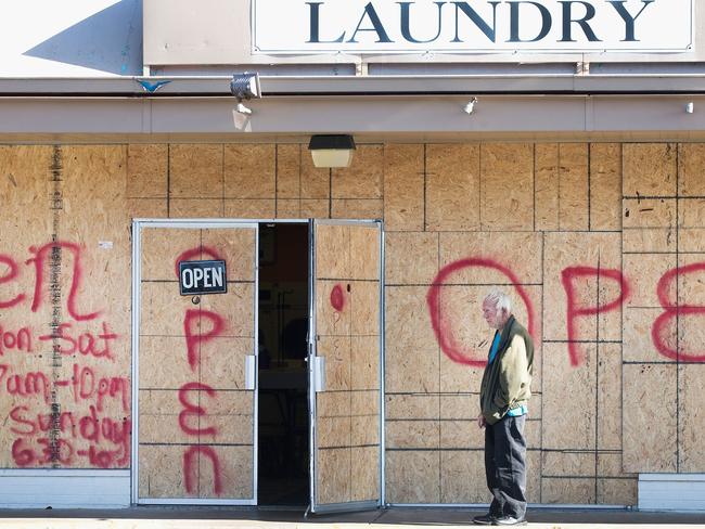 Braced against the storm ... Plywood covers the glass front of the Ferguson Laundry, located in a strip mall along West Florissant Street, in Ferguson, Missouri. Source: AFP