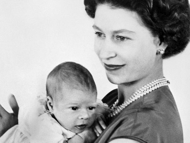 One of the first pictures of Prince Andrew shows him in Queen Elizabeth II's arms. Picture: AFP