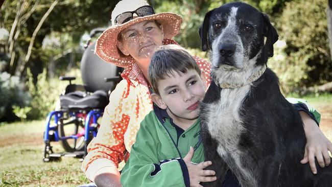 Jody Ezzy and her son Angus Hopkins and dog Boss. Angus needs a new wheelchair but NDIS keeps stalling. His mother uses a wheelbarrow to move him around outside. April 2019. Picture: Bev Lacey