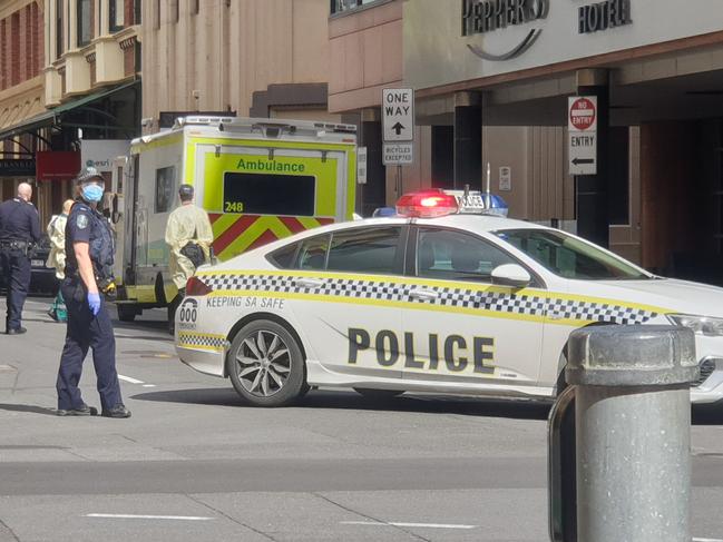 An infectious patient being transferred from the Peppers Hotel, Waymouth Street to the Pullman Hotel, Hindmarsh Square under police escort. Picture: Colin James