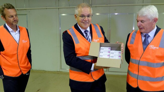 Prime Minister Scott Morrison with a palette of COVID vaccine at CSL Melbourne. Picture: NCA NewsWire / Andrew Henshaw