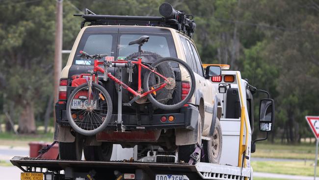 Greg Lynn’s 4WD is towed for inspection by forensics officers. Picture: David Caird