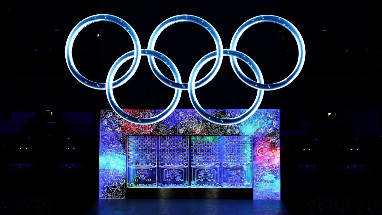 A large Olympic ring logo glows amid a spectacular light show. Picture: Lintao Zhang/Getty Images