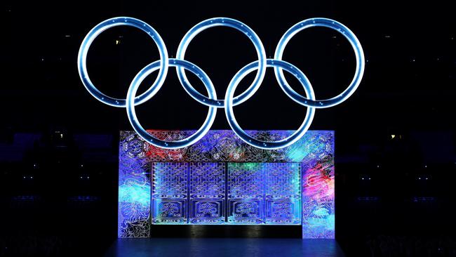 A large Olympic ring logo glows amid a spectacular light show. Picture: Lintao Zhang/Getty Images