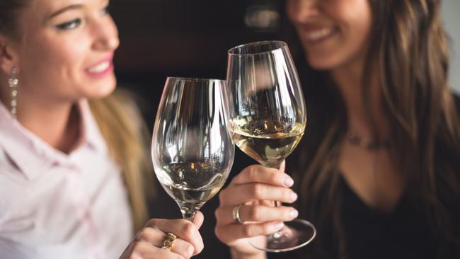 Business people toasting with white wine in restaurant. iStock image