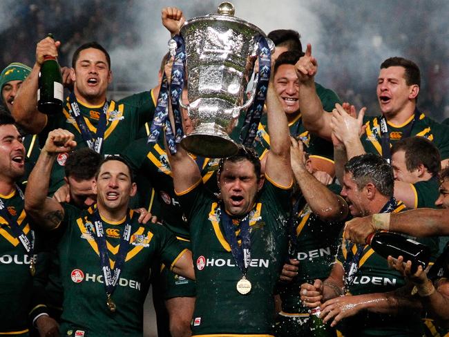 MANCHESTER, ENGLAND - NOVEMBER 30:  Captain Cameron Smith (C) of Australia celebrates with the trophy and team mates after the Rugby League World Cup final between New Zealand and Australia at Old Trafford on November 30, 2013 in Manchester, England. (Photo by Paul Thomas/Getty Images)