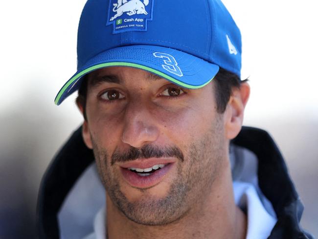 CORRECTION / RB's Australian driver Daniel Ricciardo arrives to the paddocks at the Albert Park Circuit ahead of the Formula One Australian Grand Prix in Melbourne on March 21, 2024. (Photo by Martin KEEP / AFP) / -- IMAGE RESTRICTED TO EDITORIAL USE - STRICTLY NO COMMERCIAL USE -- / âThe erroneous mention[s] appearing in the metadata of this photo by Martin KEEP has been modified in AFP systems in the following manner: [RB's Australian driver Daniel Ricciardo] instead of [SIC58 Squadra Corse's Italian rider Riccardo Rossi arrives]. Please immediately remove the erroneous mention[s] from all your online services and delete it (them) from your servers. If you have been authorized by AFP to distribute it (them) to third parties, please ensure that the same actions are carried out by them. Failure to promptly comply with these instructions will entail liability on your part for any continued or post notification usage. Therefore we thank you very much for all your attention and prompt action. We are sorry for the inconvenience this notification may cause and remain at your disposal for any further information you may require.â