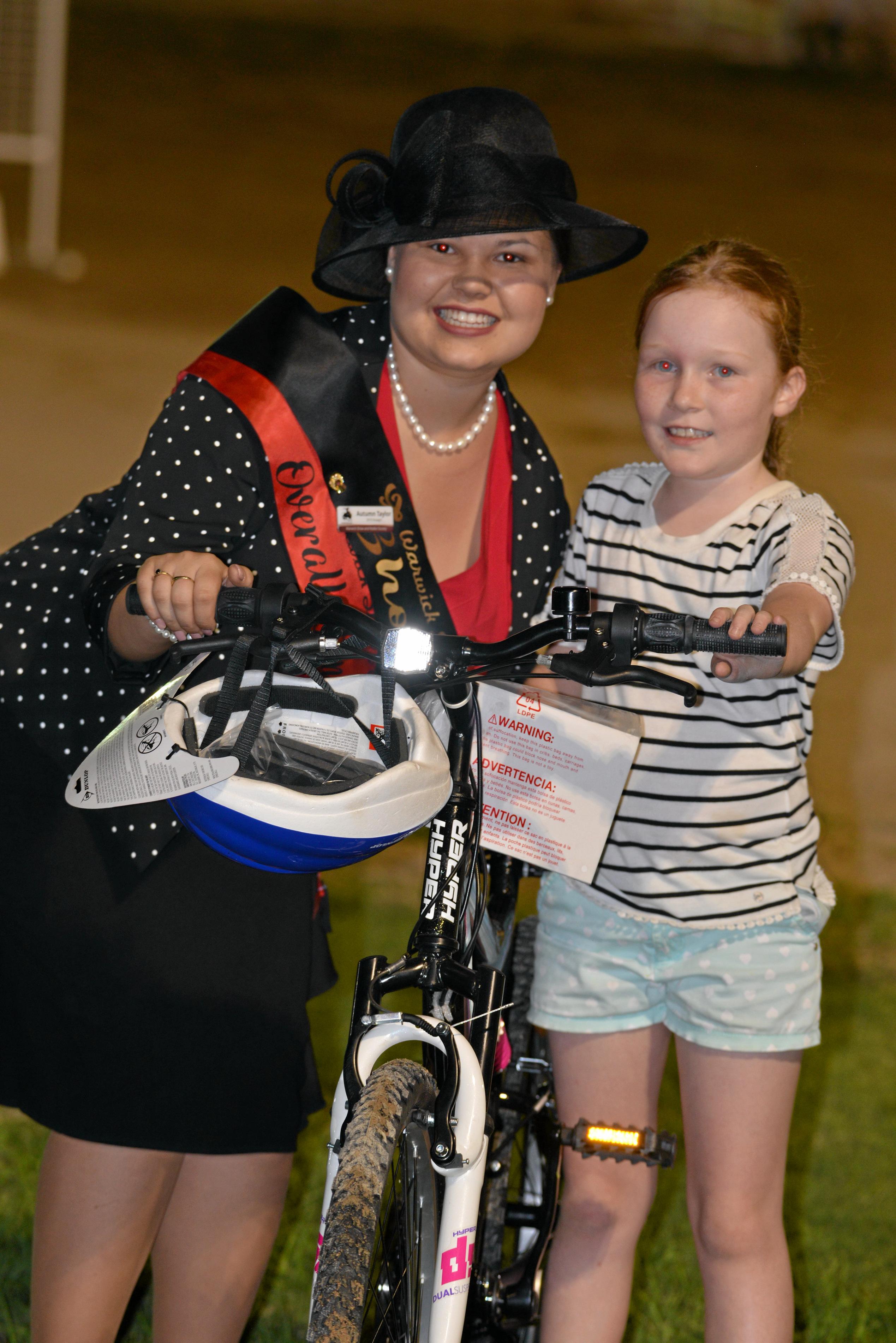 Warwick Showgirl Autumn Taylor with Lizzie Gillespie who won a  bike from Carey Brothers after the ping pong ball drop at the Warwick Show. Picture: Gerard Walsh