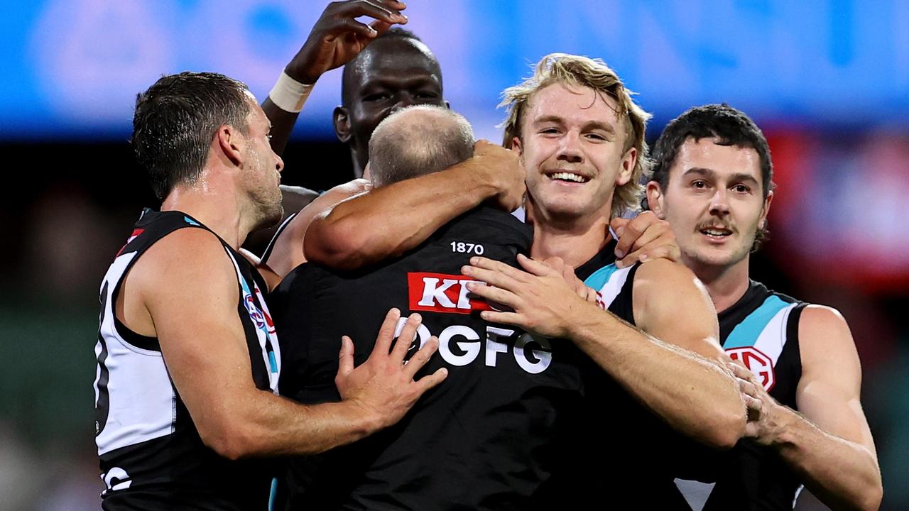 Port Adelaide players Travis Boak, Aliir Aliir, Jason Horne-Francis and Darcy Byrne-Jones celebrate with coach Ken Hinkley. Picture: Brendon Thorne/AFL Photos