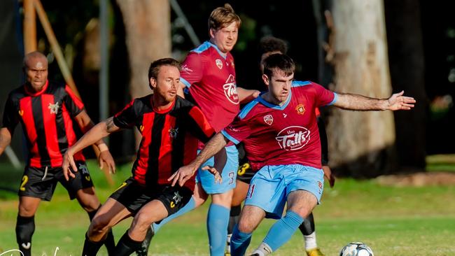 St Alban's Scott Forknall takes control of the ball.