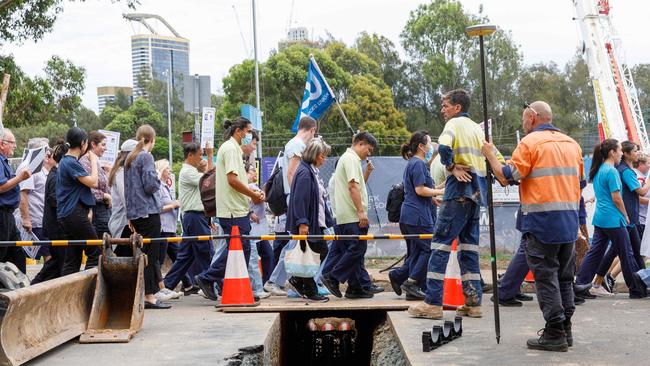 Protesters march past construction for a new car park. Picture: Max Mason-Hubers