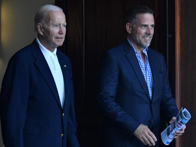 US President Joe Biden (L) alongside his son Hunter Biden  exit Holy Spirit Catholic Church after attending mass in Johns Island, South Carolina on August 13, 2022. (Photo by Nicholas Kamm / AFP)