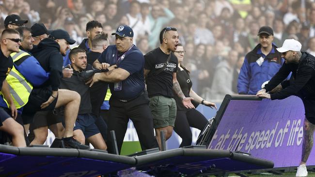 Fans storm the pitch. Picture: Darrian Getty Images