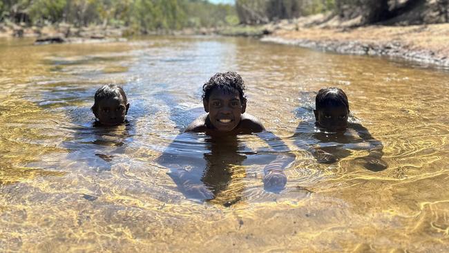 Bundy Namarnyilk, Zakarakis Namarnyilk and Sylvario Gumurdul swimming at Kaparri - part of a seven-day bushwalk students from Nawarddeken Academy's Mamadawerre school took part in with elders. Picture: Cody Thomas