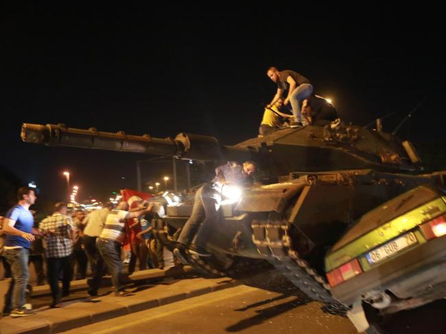 A tank crushes a car as people take to the streets in Ankara. Picture: Adem Altan