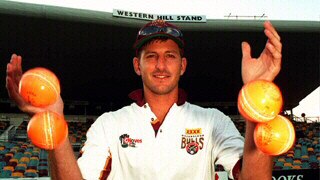 Michael Kasprowicz juggles the new orange balls used in day night matches.