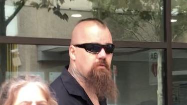 Satudarah bikie Steven John Berrier, 38, at Blacktown Local Court with a family member after being charged with a child abuse material offence.