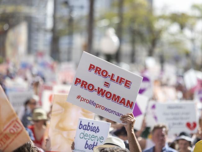 Protesters hold placards during a pro-life rally in Brisbane. Picture: Glenn Hunt/AAP