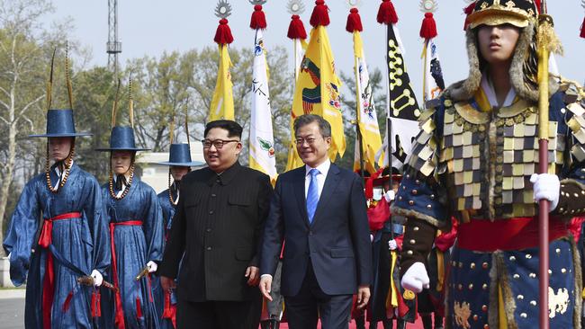 A ceremonial guard leads Kim Jong-un and Moon Jae-in through the truce village of  Panmunjom.Picture; AP.