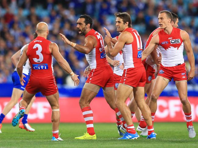 Adam Goodes (second left) celebrates kicking a goal for the Swans against the Kangaroos.