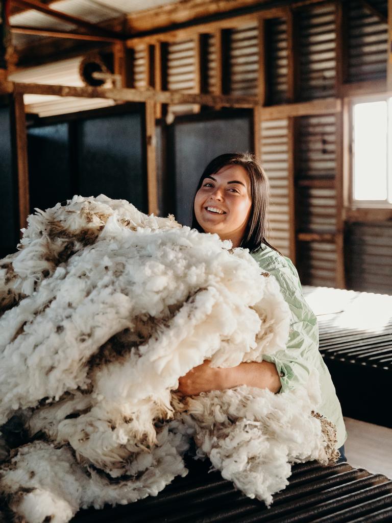 Shine Awards nominee Sophie Murfitt with wool fleece on the family farm of her partner, Will, at Triabunna.