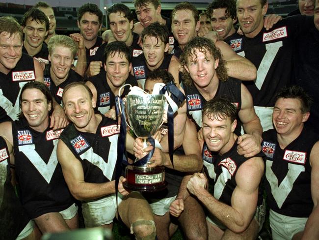 Couch far right celebrates with team mates and the 1995 State of Origin trophy.