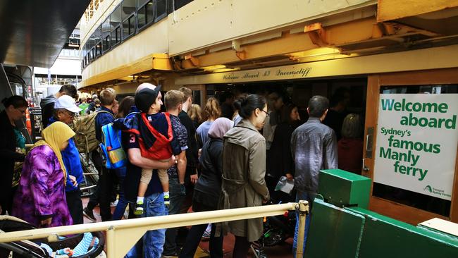 Crowds of people line up to catch the Manly Ferry at Circular Quay. Picture: Toby Zerna