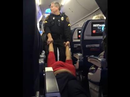 Woman dragged off plane like a ragdoll