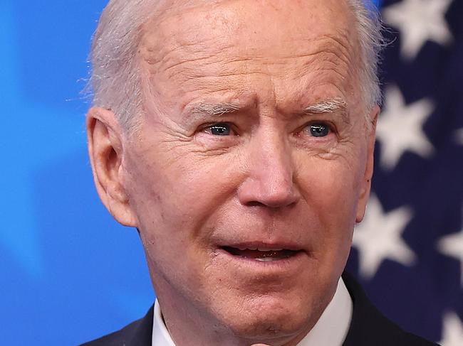 WASHINGTON, DC - MARCH 24: U.S. President Joe Biden replaces his face mask following an Equal Pay Day event in the South Court Auditorium in the Eisenhower Executive Office Building on March 24, 2021 in Washington, DC. Highlighting the gender pay gap, Equal Pay Day raises awareness that women in the United States earned $0.82 for every dollar men earned in 2019, according to the National Committee on Pay Equity.   Chip Somodevilla/Getty Images/AFP == FOR NEWSPAPERS, INTERNET, TELCOS & TELEVISION USE ONLY ==