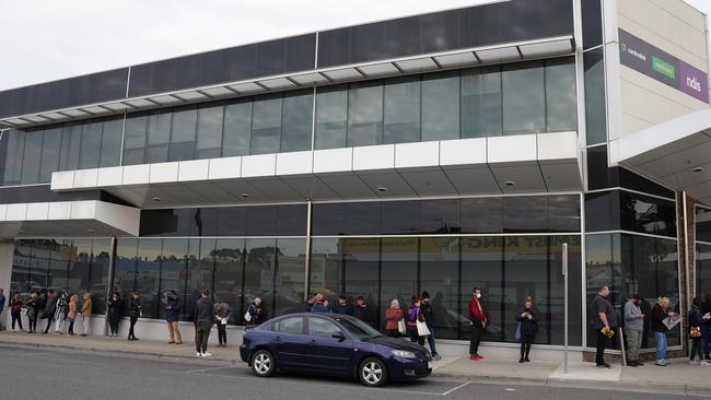 People queuing outside a Centrelink office in Preston on Tuesday. Picture: AAP Image/Stefan Postles