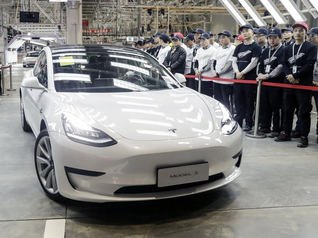 A Tesla Model 3 moves off an assembly line during a ceremony at the Shanghai Gigafactory. Picture: Qilai Shen/Bloomberg News