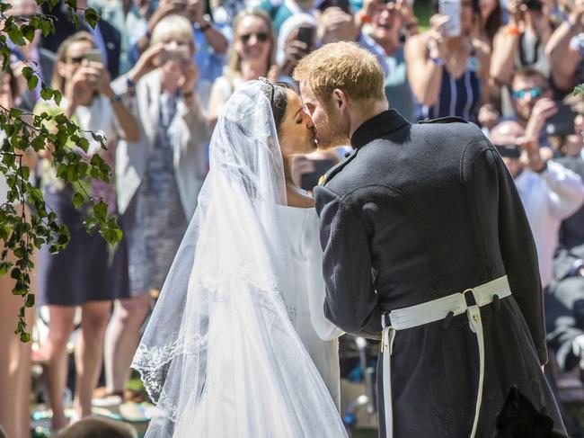 Prince Harry and Meghan Markle kiss on the steps of St George's Chapel in Windsor Castle after their wedding at Windsor Castle in 2018. Picture: WPA Pool/Getty Images