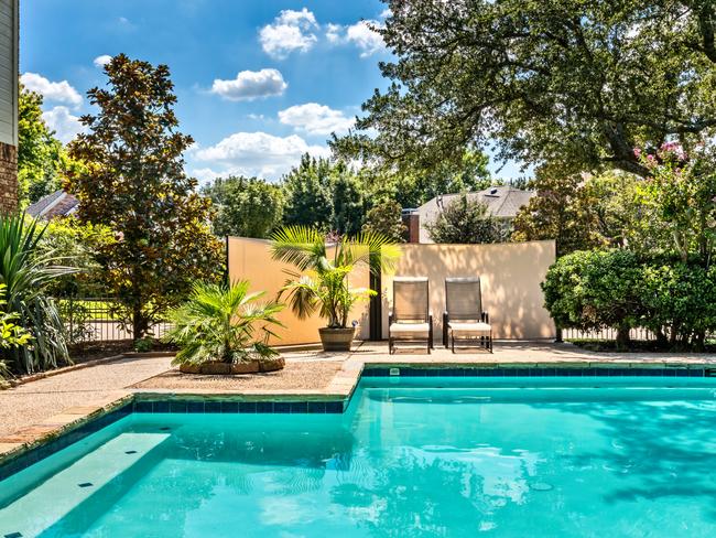 Backyard oasis with a swimming pool inside a private residential backyard