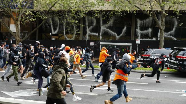 Demonstrators target a police car during a protest against Covid-19 regulations in Melbourne on September 21, 2021. Picture: AFP