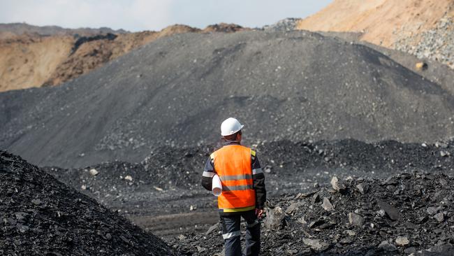 Coal mining in an open pit - Worker is looking on the huge open pit