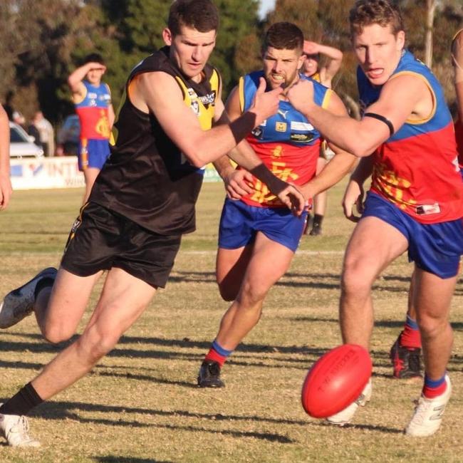 Cobram's Sam Beasley, left, brushes past Mulwala opponents in the Murray league. Picture: Supplied